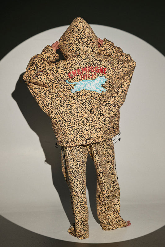 achterkant van de puffer met champagne tiger patch, capuchon op gezet