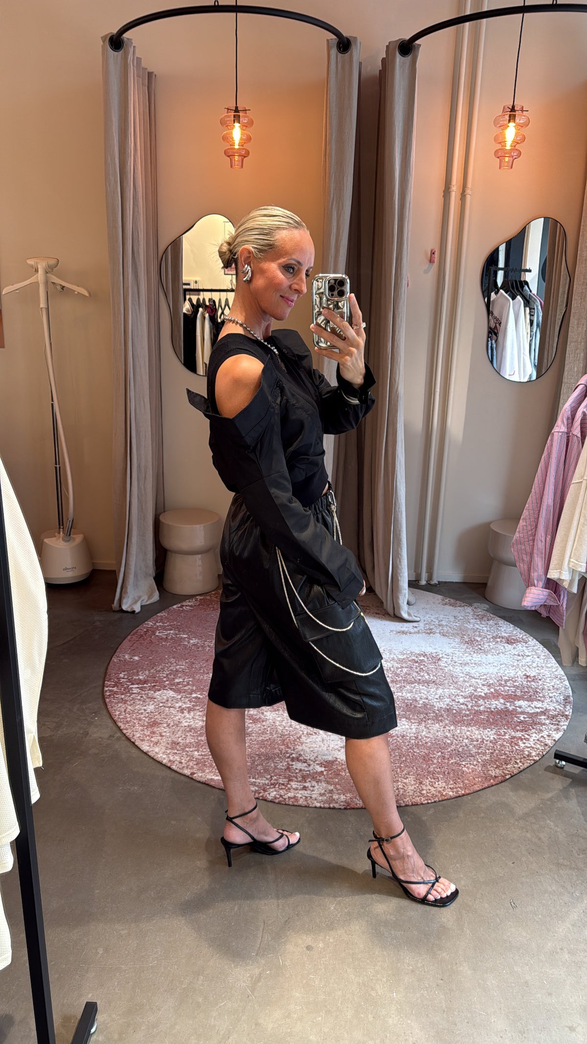 zijaanzicht van model in jort vegan leather black met ketting detail aan de zak